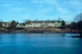 the large house is behind a lake with water around it