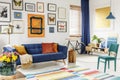 Spacious living room interior with a blanket and orange pillows