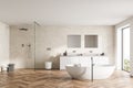 Spacious modern bathroom design interior in wood tones with parquet floor, freestanding tub, walk-in shower, double sink vanity. Royalty Free Stock Photo