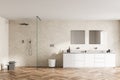 Spacious modern bathroom design interior in wood tones with parquet floor, walk-in shower, double sink vanity. Window light Royalty Free Stock Photo