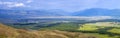 Spacious mountain valley. Cloudy weather. The contrast of dark clouds and light