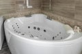 Spacious newempty jacuzzi bath tube in bathroom interior with modern tile Royalty Free Stock Photo