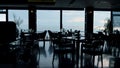 Spacious panoramic restaurant interior in evening dusk. Business lunch concept Royalty Free Stock Photo
