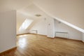 Spacious room on the attic floor of a single-family home with skylights and aluminum radiators