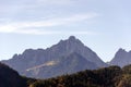 A spacious view of the Alps mountains covered with colorful trees on a sunny October day near Innsbruck, Austria