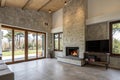Spacious villa interior with cement wall and fireplace Royalty Free Stock Photo
