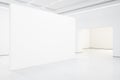 Spacious white gallery interior with empty exhibition stand Royalty Free Stock Photo