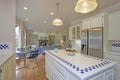 Spacious white kitchen interior with kitchen island.