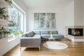 Spacious white living room interior with grey couch Royalty Free Stock Photo