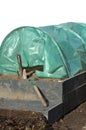 Spade raised garden bed and polytunnels Royalty Free Stock Photo