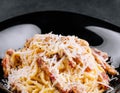 Spagetti carbonara on a black plate Royalty Free Stock Photo