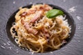Spagetti carbonara on a black plate Royalty Free Stock Photo