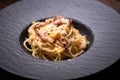 Spagetti carbonara on a black plate Royalty Free Stock Photo