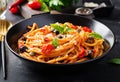 Spaghetti alla puttanesca - italian pasta dish with tomatoes, black olives, capers, anchovies Royalty Free Stock Photo