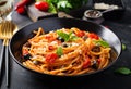 Spaghetti alla puttanesca - italian pasta dish with tomatoes, black olives, capers, anchovies Royalty Free Stock Photo