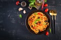 Spaghetti alla puttanesca - italian pasta dish with tomatoes, black olives, capers, anchovies Royalty Free Stock Photo