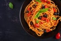 Spaghetti alla puttanesca - italian pasta dish with tomatoes, black olives, capers, anchovies Royalty Free Stock Photo