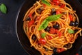 Spaghetti alla puttanesca - italian pasta dish with tomatoes, black olives, capers, anchovies Royalty Free Stock Photo