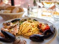 Spaghetti allo scoglio or spaghetti with seafood served in a white dish with shrimps