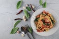 Spaghetti Bacon chili garlic basil in white plate on gray background. Popular menu classic italian cuisine dish. Royalty Free Stock Photo