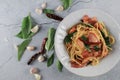 Spaghetti Bacon chili garlic basil in white plate on gray background. Popular menu classic italian cuisine dish. Royalty Free Stock Photo