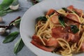 Spaghetti Bacon chili garlic basil in white plate on gray background. Popular menu classic italian cuisine dish. Royalty Free Stock Photo