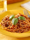 Spaghetti with basil garnish in meat sauce