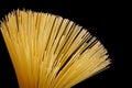 Spaghetti on a black background, popular food. Spaghetti is a kind of pasta made of dried wheat dough, thin with a round section.