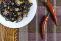 Spaghetti black with seafood and vegetables on a white plate multi-colored background top view Royalty Free Stock Photo