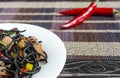 Spaghetti black with seafood and vegetables on a white plate multi-colored background top view Royalty Free Stock Photo