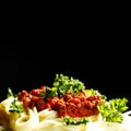 Spaghetti bolognese in black plate Royalty Free Stock Photo