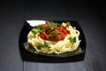 Spaghetti bolognese in black plate Royalty Free Stock Photo