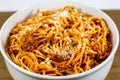 Spaghetti Bolognese in a deep white bowl on the wooden kitchen table waiting to be eaten Royalty Free Stock Photo