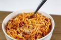 Spaghetti Bolognese in a deep white bowl on the wooden kitchen table waiting to be eaten Royalty Free Stock Photo
