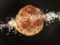 Spaghetti Bolognese dish, top view, black background