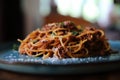 Spaghetti Bolognese with minced beef and tomato sauce garnished with parmesan cheese and basil , Italian food