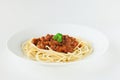 Spaghetti Bolognese with parsley in white plate