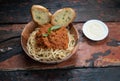 Homemade healthy italian pasta with toasted garlic bread on rustic wooden background