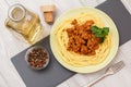 Spaghetti bolognese on a plate with metal fork and bottle of wine Royalty Free Stock Photo