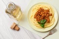 Spaghetti bolognese on a plate with metal fork and bottle of wine Royalty Free Stock Photo