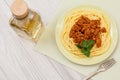 Spaghetti bolognese on a plate with metal fork and bottle of wine Royalty Free Stock Photo