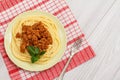 Spaghetti bolognese on a plate with metal fork and napkin Royalty Free Stock Photo