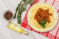 Spaghetti bolognese on a plate, spices and herbs with a napkin Royalty Free Stock Photo