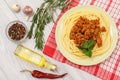 Spaghetti bolognese on a plate, spices and herbs with a napkin Royalty Free Stock Photo