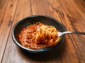 Spaghetti Bolognese ready meal in black plastic container on wooden table. Premium, high quality traditional Italian style ready Royalty Free Stock Photo