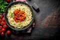 Spaghetti with Bolognese sauce in pan on a napkin with tomatoes and parsley Royalty Free Stock Photo