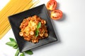 Spaghetti Bolognese with tomato sauce,sausage and basil in black plate Royalty Free Stock Photo