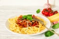 Spaghetti bolognese on a white plate with fork on white wooden table. healthy food Royalty Free Stock Photo