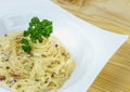Spaghetti Cabonara with creamy sauce on wooden table Royalty Free Stock Photo