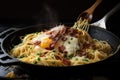 spaghetti carbonara being cooked in a skillet, with bacon and eggs frying